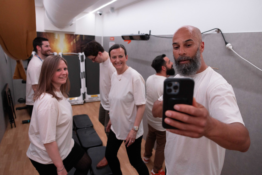 A group of 5 cheerful people engaging in physical activity during the ChangeNow event.