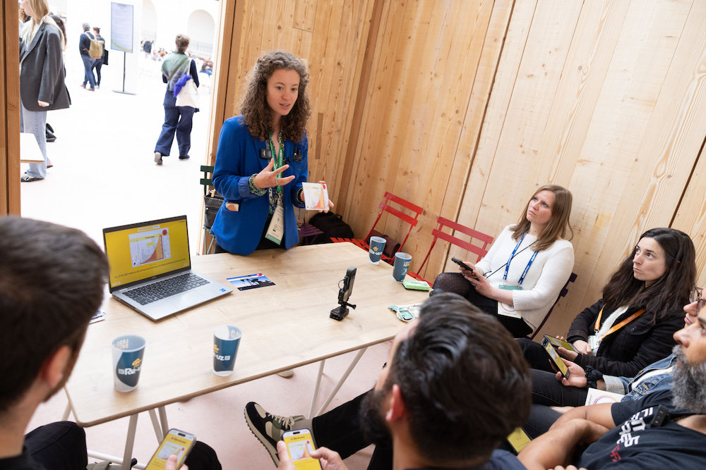 Woman in a suit presenting climate data during the ChangeNow event.