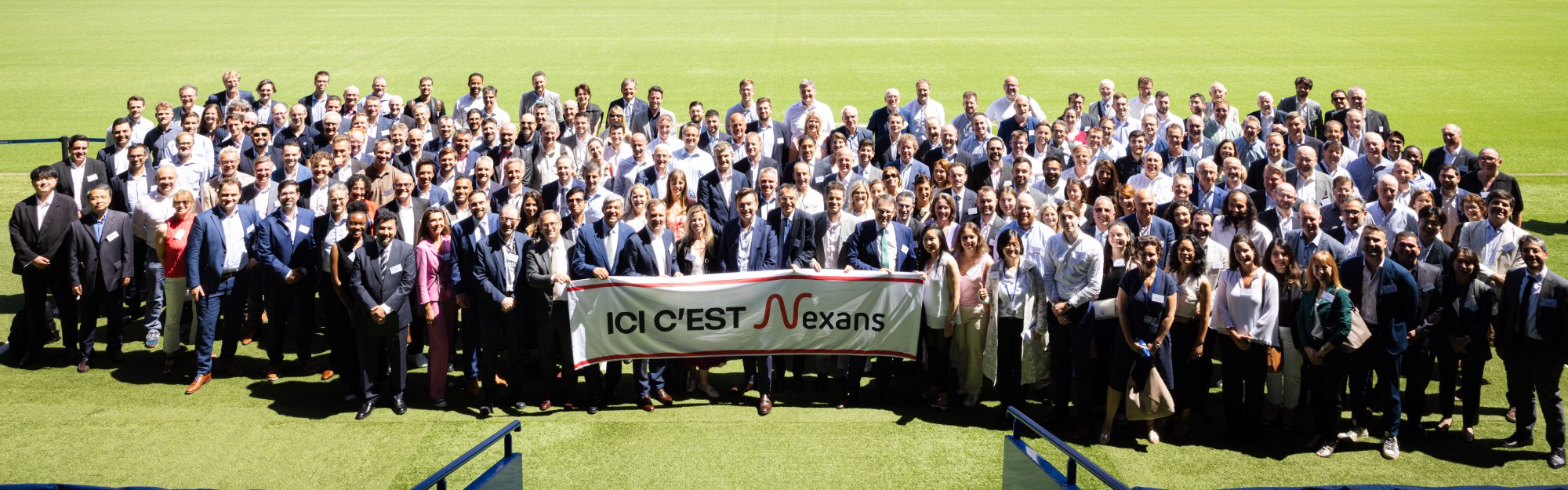 Group photo of diverse professionals at a suppliers' day event, showcasing camaraderie and teamwork.